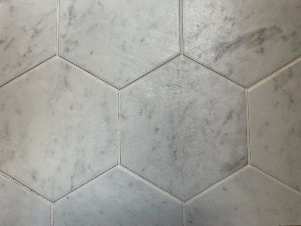 Bistrot matte porcelain tile with a white marble design, for floors and walls. Made in Italy, in a 7" hexagon size.