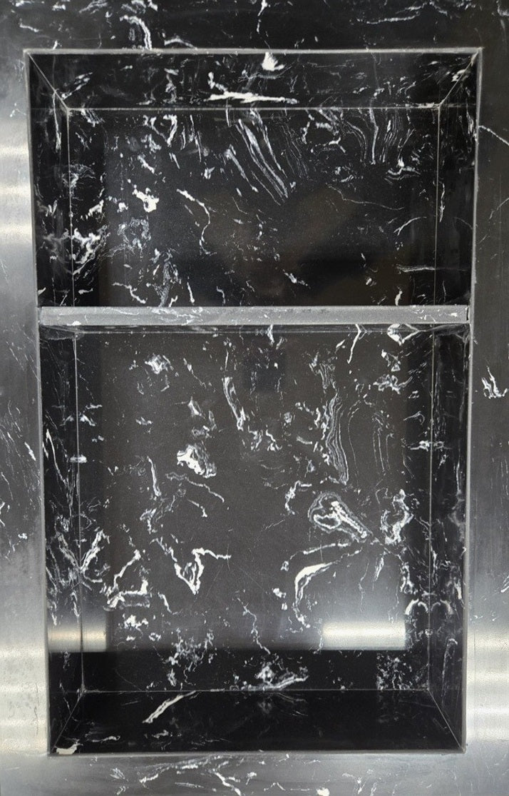 Black Marquina prebuilt quartz shower niche made of engineered stone that offers shower storage, with a shelf.