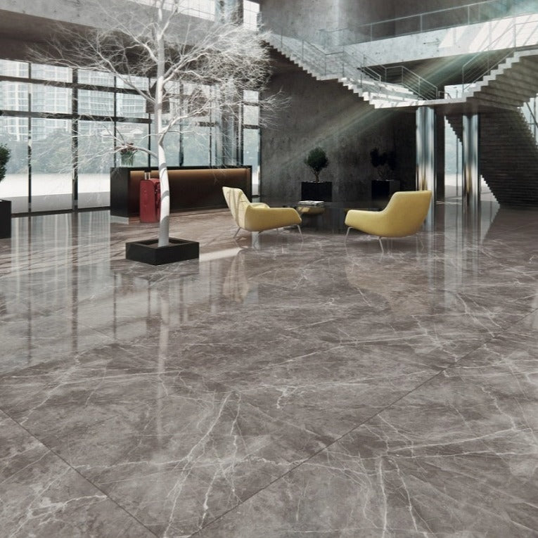 Bolonia polished porcelain tile with a grey stone design, for floors and walls. Made in Spain, installed in a room.