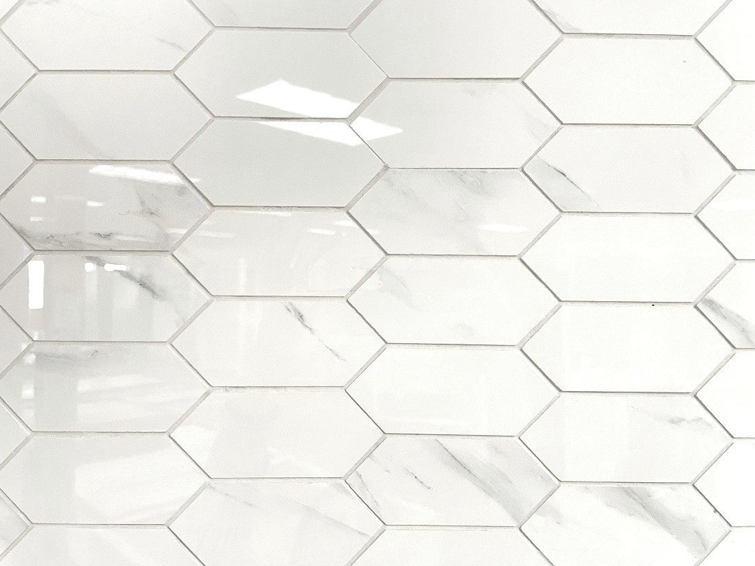 Calacatta Argento polished porcelain mosaic with a white marble design, for floors and walls. In an elongated hexagon.