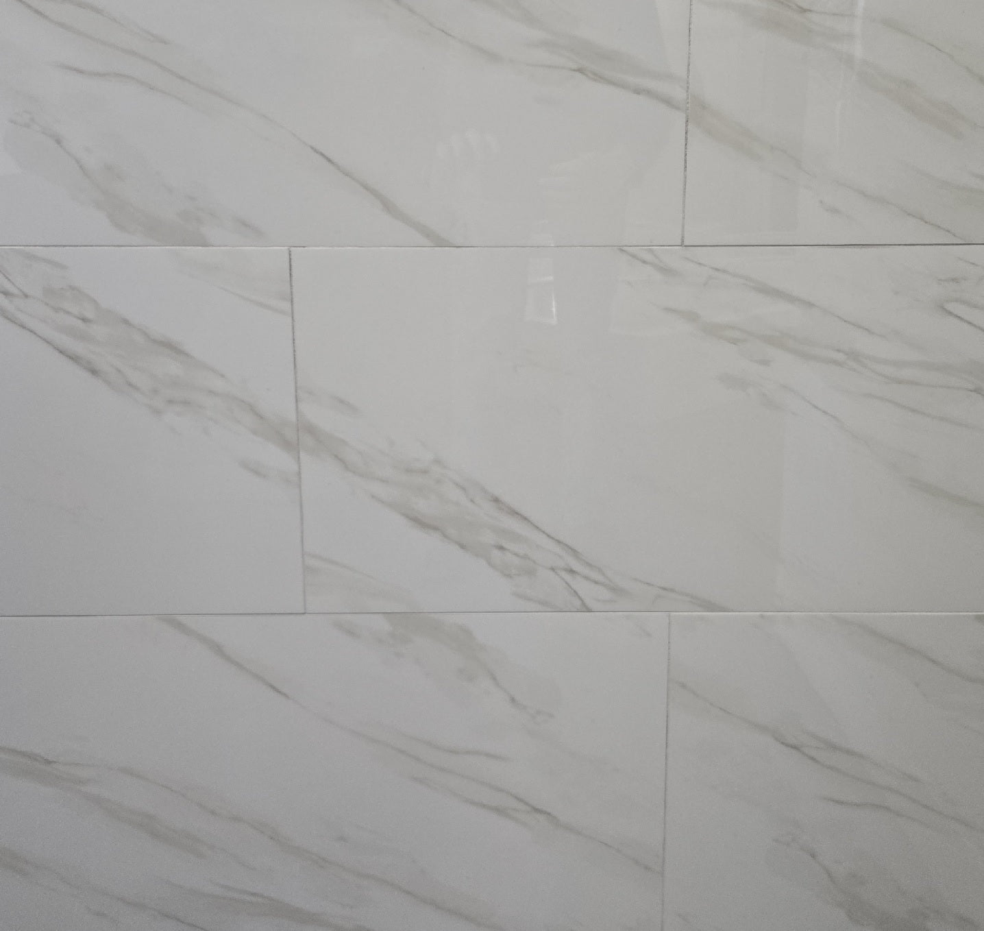 Calacatta Honey polished porcelain tile with a white marble design, for floors and walls. In a 12x24" size.