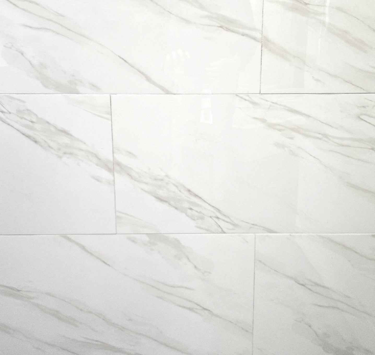 Calacatta Honey polished porcelain tile with a white marble design, for floors and walls. In a 12x24" size.
