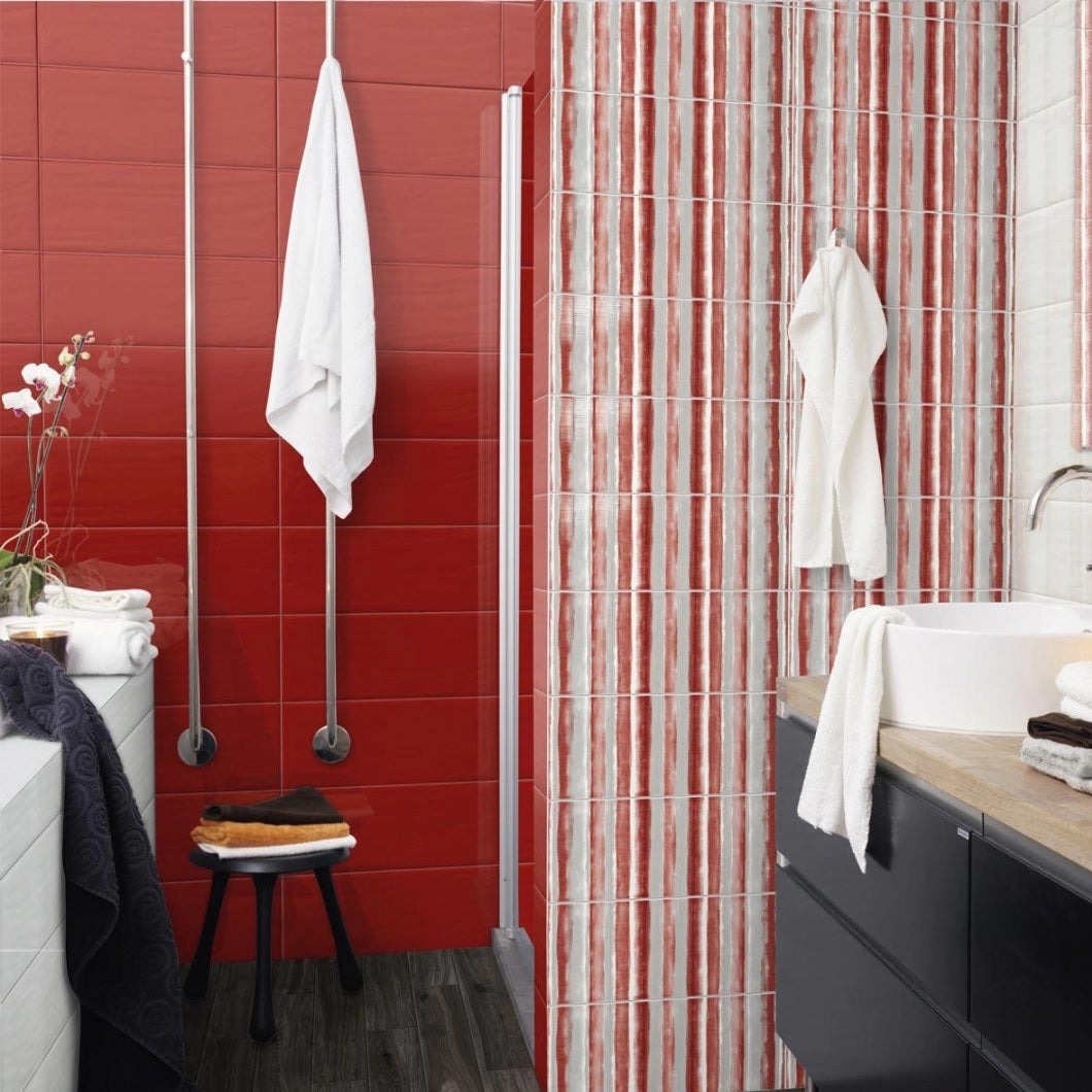 Candy Granata glossy ceramic tile with a red design, for walls. Made in Italy, installed on a bathroom wall.