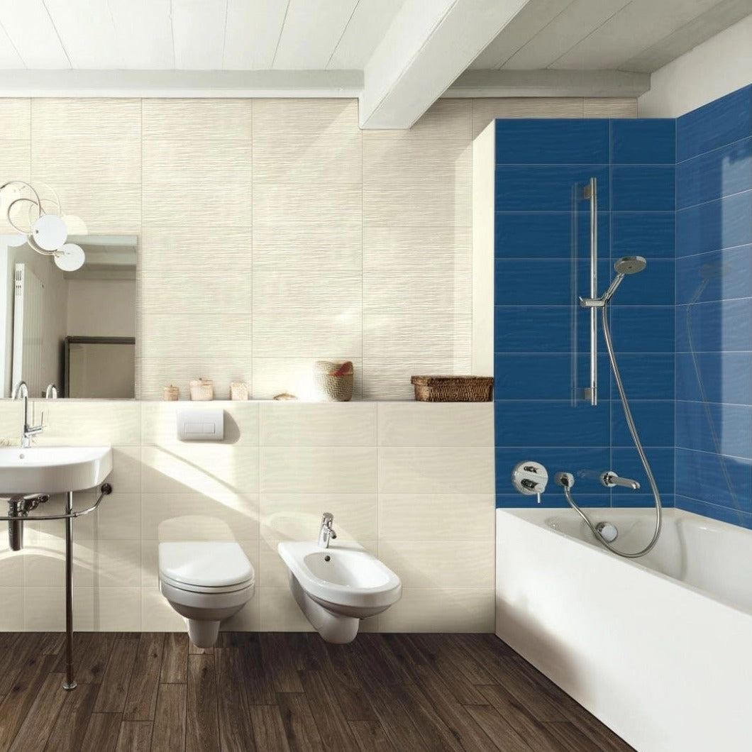 Candy Oltremare glossy ceramic tile with a royal blue design, for walls. Made in Italy, installed on a shower wall.