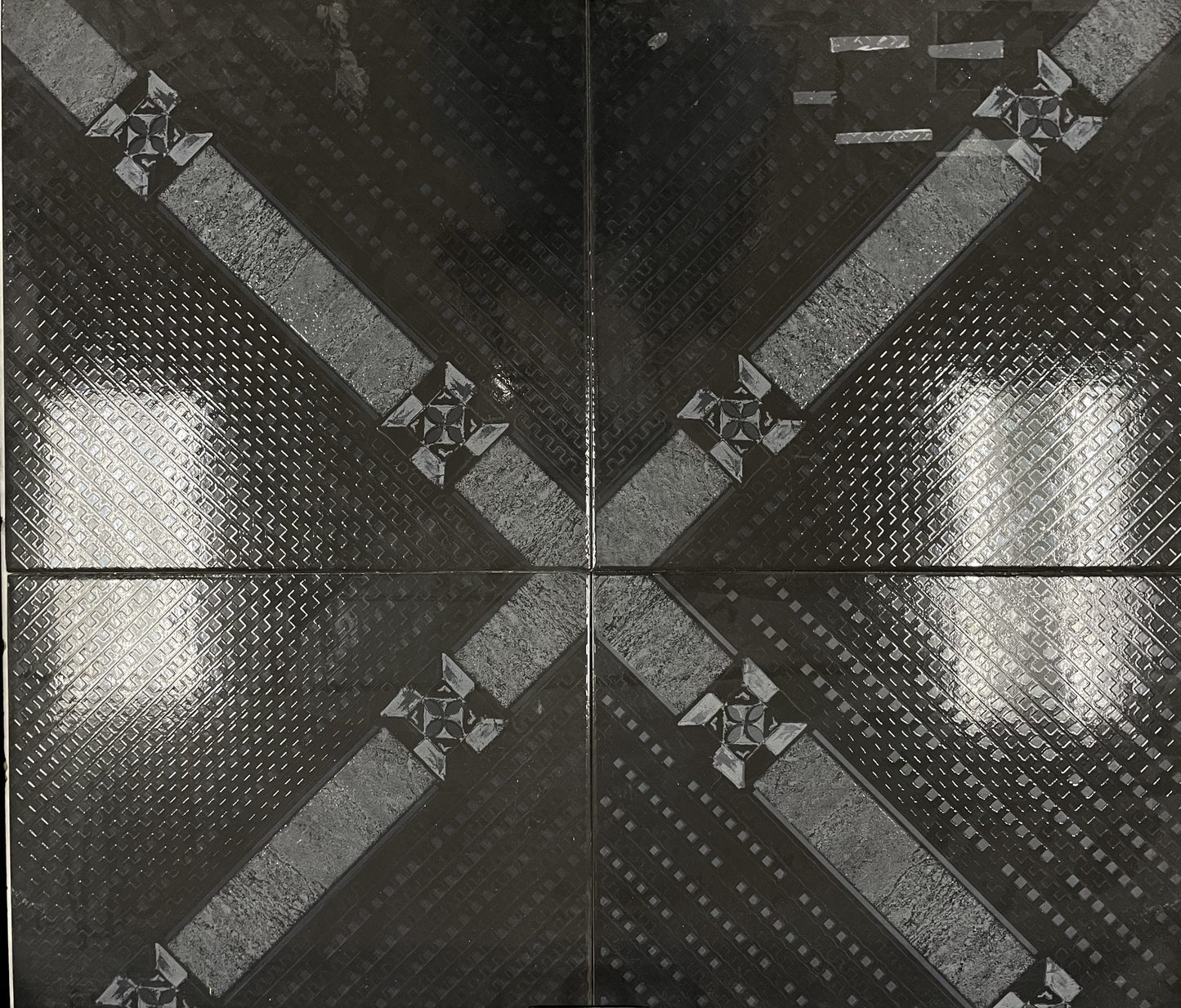 Capri Black glossy ceramic tile with a black and white diagonal connecting pattern. In a 18x18" size.