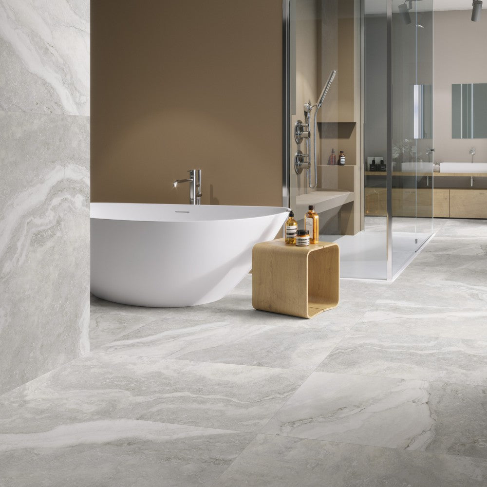 Caracalla Antracita porcelain tile with a travertine design, for floors and walls. Made in Spain, installed in a room.