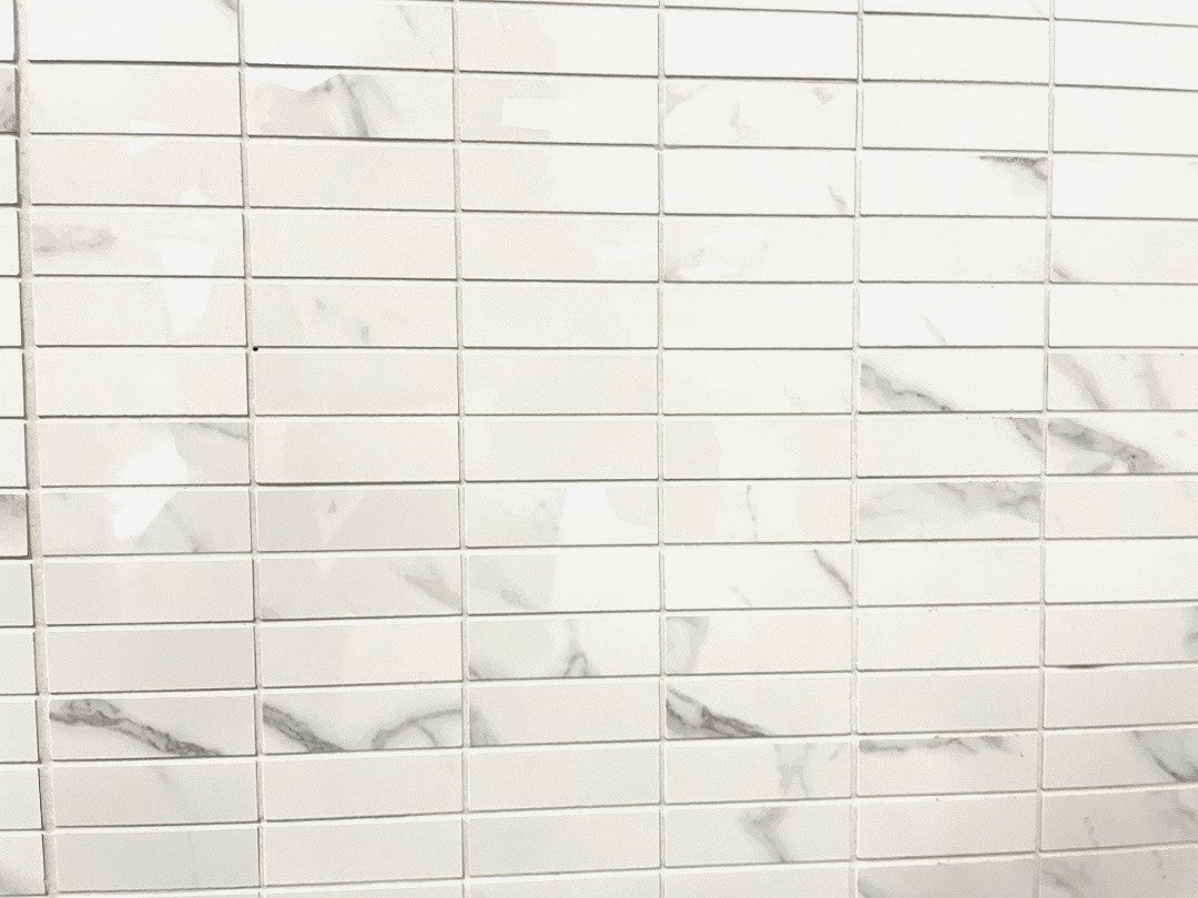 Carrara Royale polished porcelain tile in a white marble style, for floors and walls. In a rectangle mosaic size.