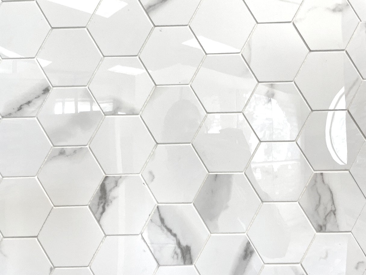 Carrara Simpatico polished porcelain mosaic with a white marble design, for floors and walls. In a 5" hexagon size.