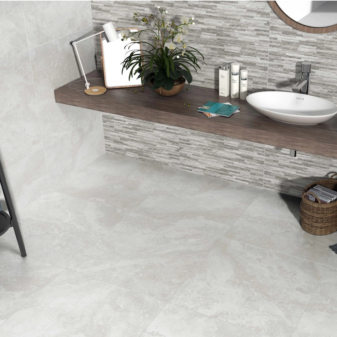 Cipriani Blanco matte porcelain tile with a white stone/cement design, for floors and walls. Installed in a room.