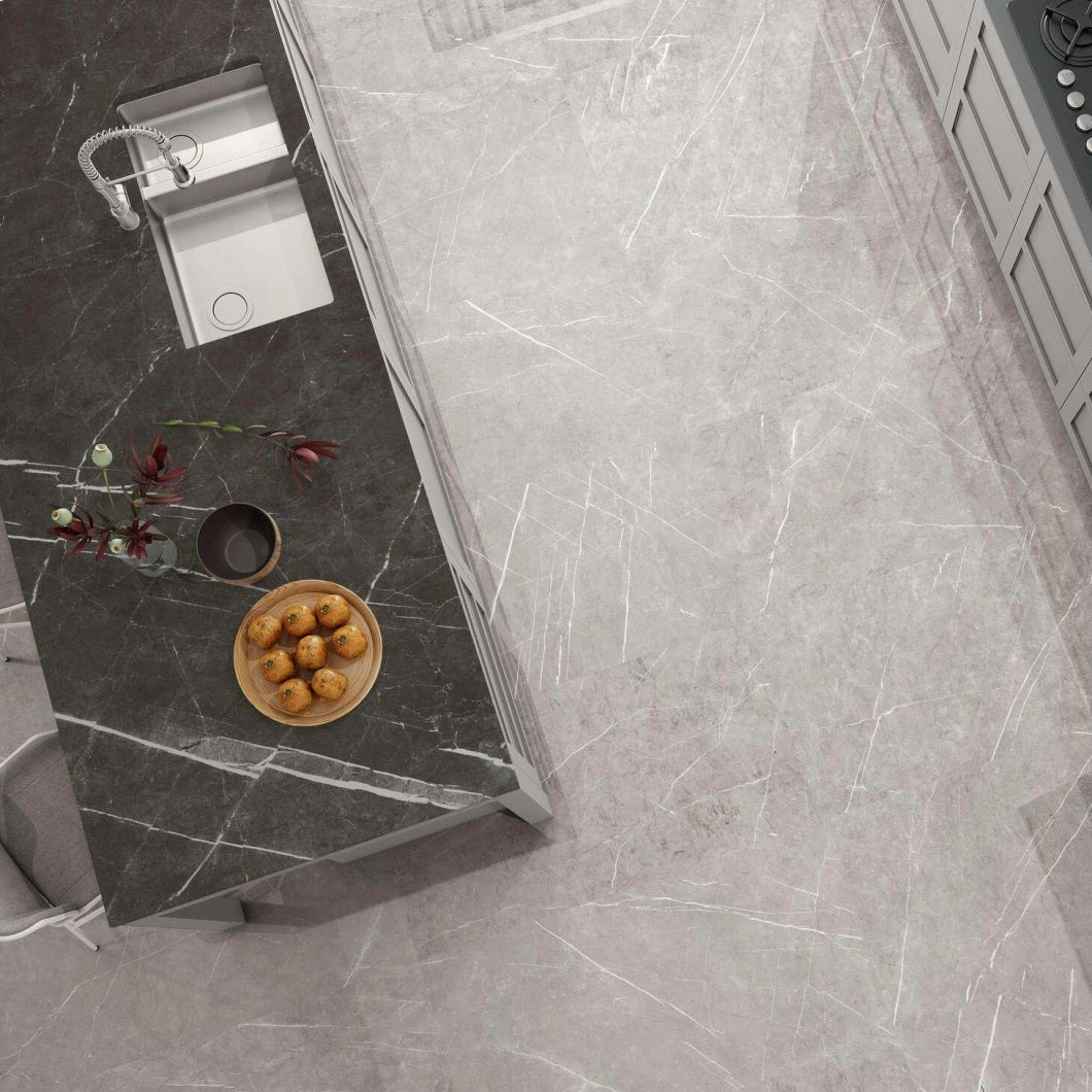 Columbia Perla porcelain tile with a grey stone design, for floors and walls. Made in Spain, installed in a room.