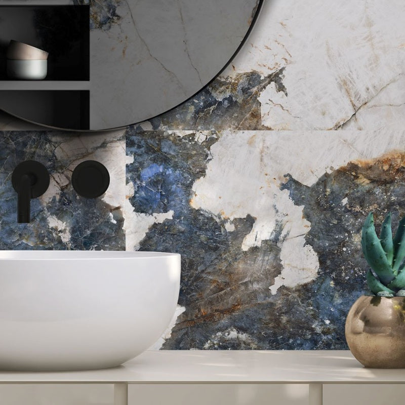 Crystal Sea polished porcelain tile with a warm white and blue marble design, for floors and walls. Installed in a room.