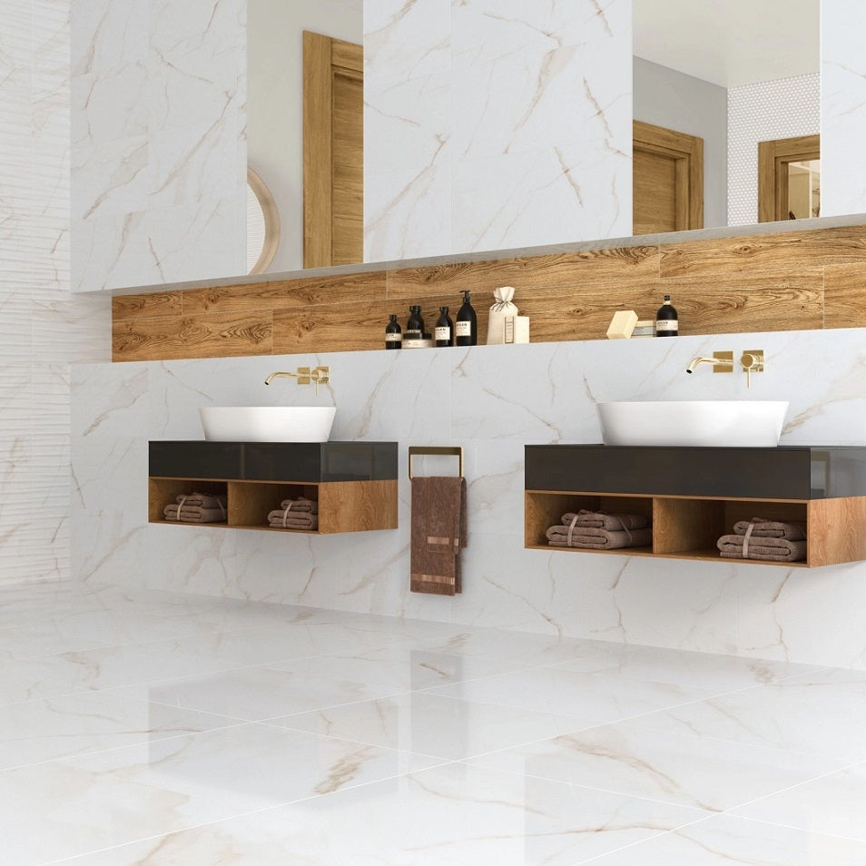 Essential Gold glossy porcelain tile with a white and gold marble design, for floors and walls. Installed in a bathroom.