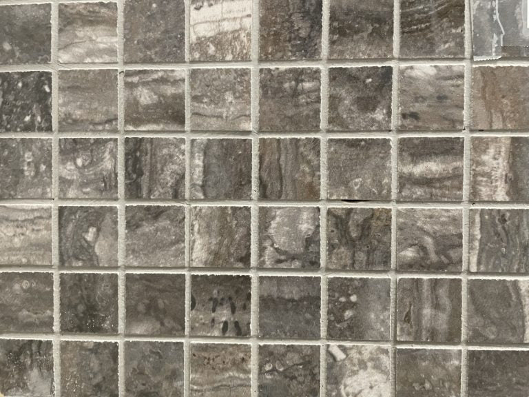 Ferrara Brown-Black polished porcelain tile with a stone design, for floors and walls. In a 1x1" square mosaic size.