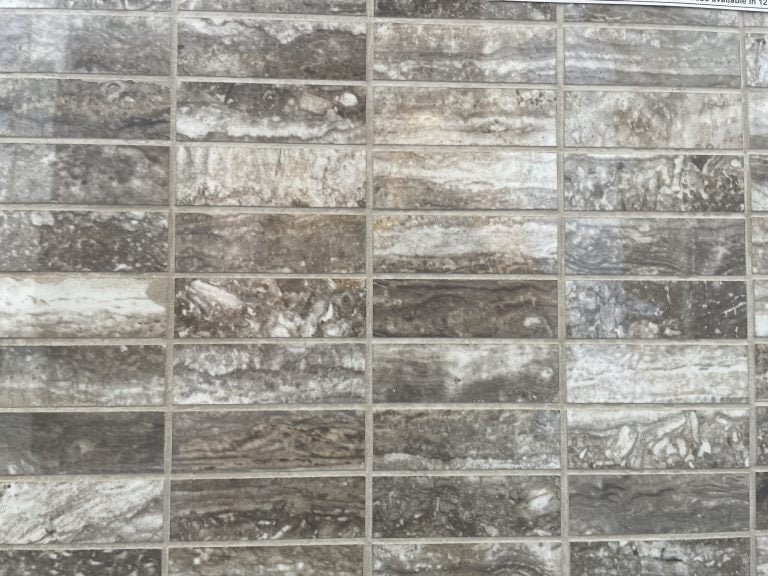 Ferrara Noce polished porcelain tile with a brown stone design, for floors and walls. In a 1x3" rectangle mosaic size.