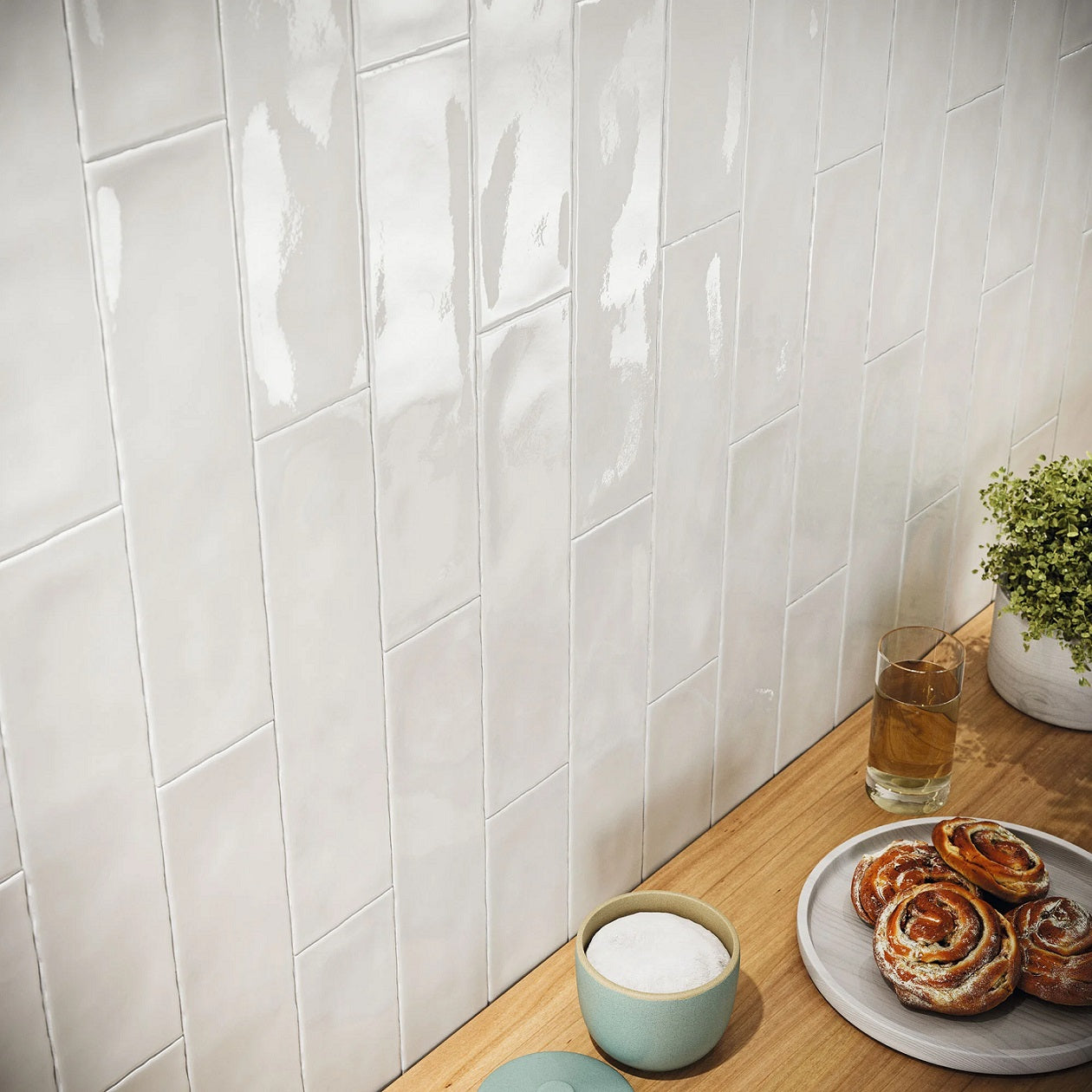 Fez White artisan style glossy ceramic subway tile with non-flat edge and surface, for walls. Installed on a backsplash.