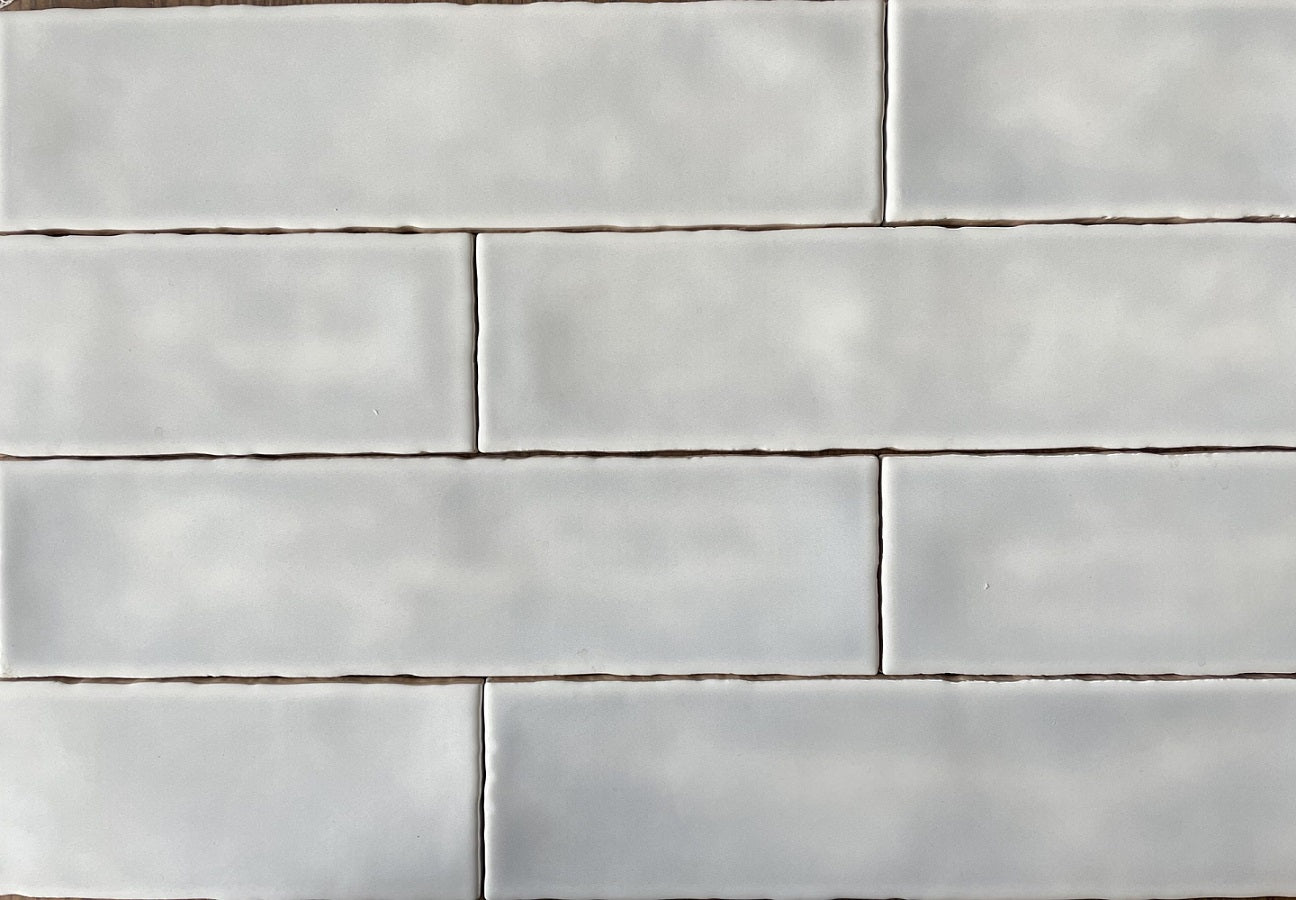 Fez White Spanish artisan style glossy ceramic subway tile with non-flat edges and surface, for walls. In a 3x12" size.