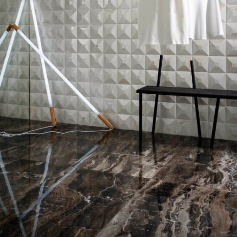 Frappuccino polished porcelain tile with a brown marble design, for floors and walls. Installed in a room.