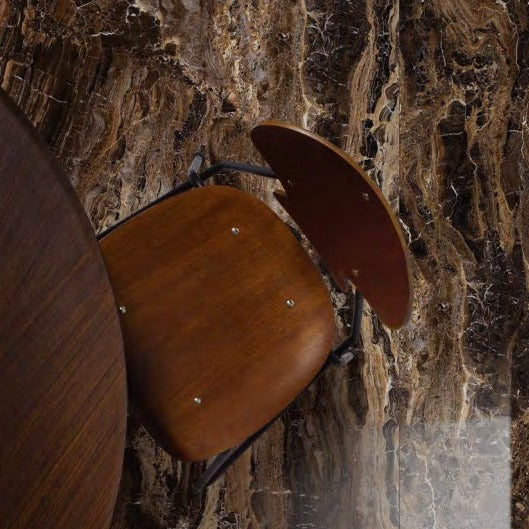 Frappuccino polished porcelain tile with a brown marble design, for floors and walls. Installed in a room.