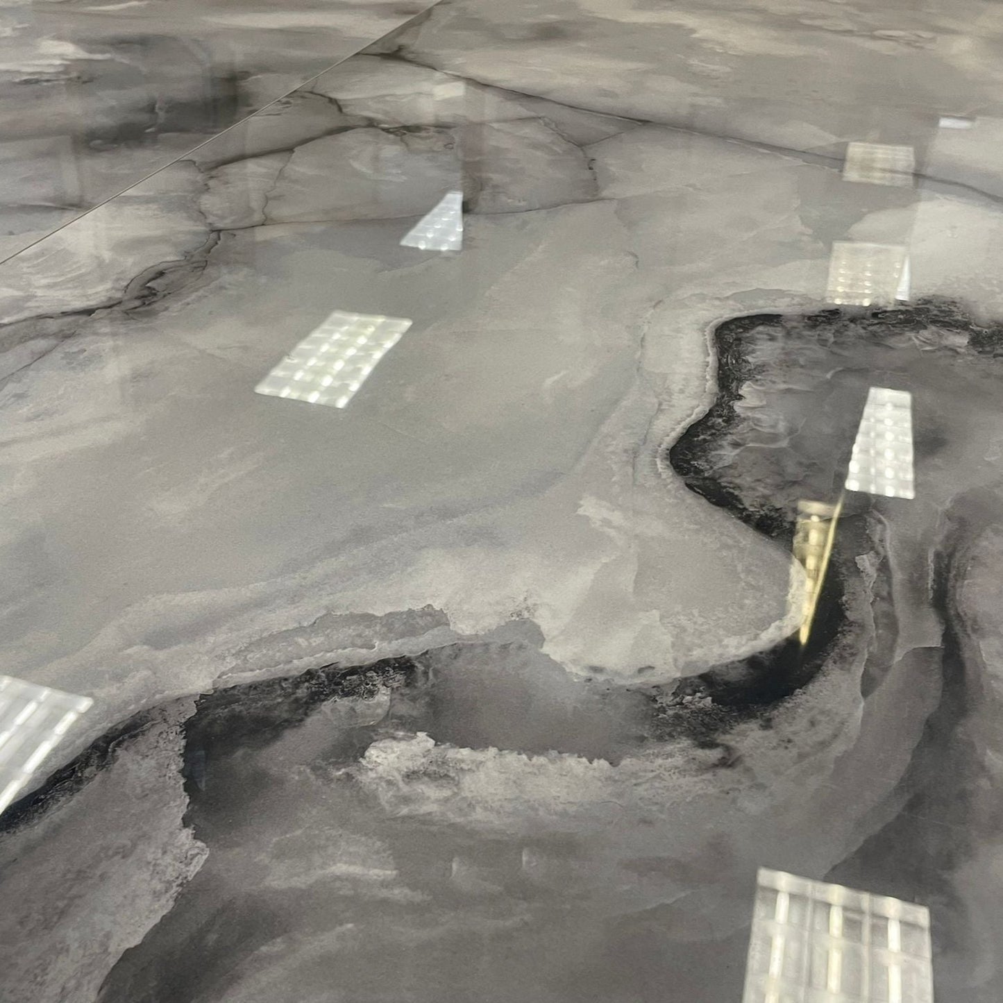 Glacial Nebula polished porcelain tile with light and dark grey onyx style. A close up of the tile.