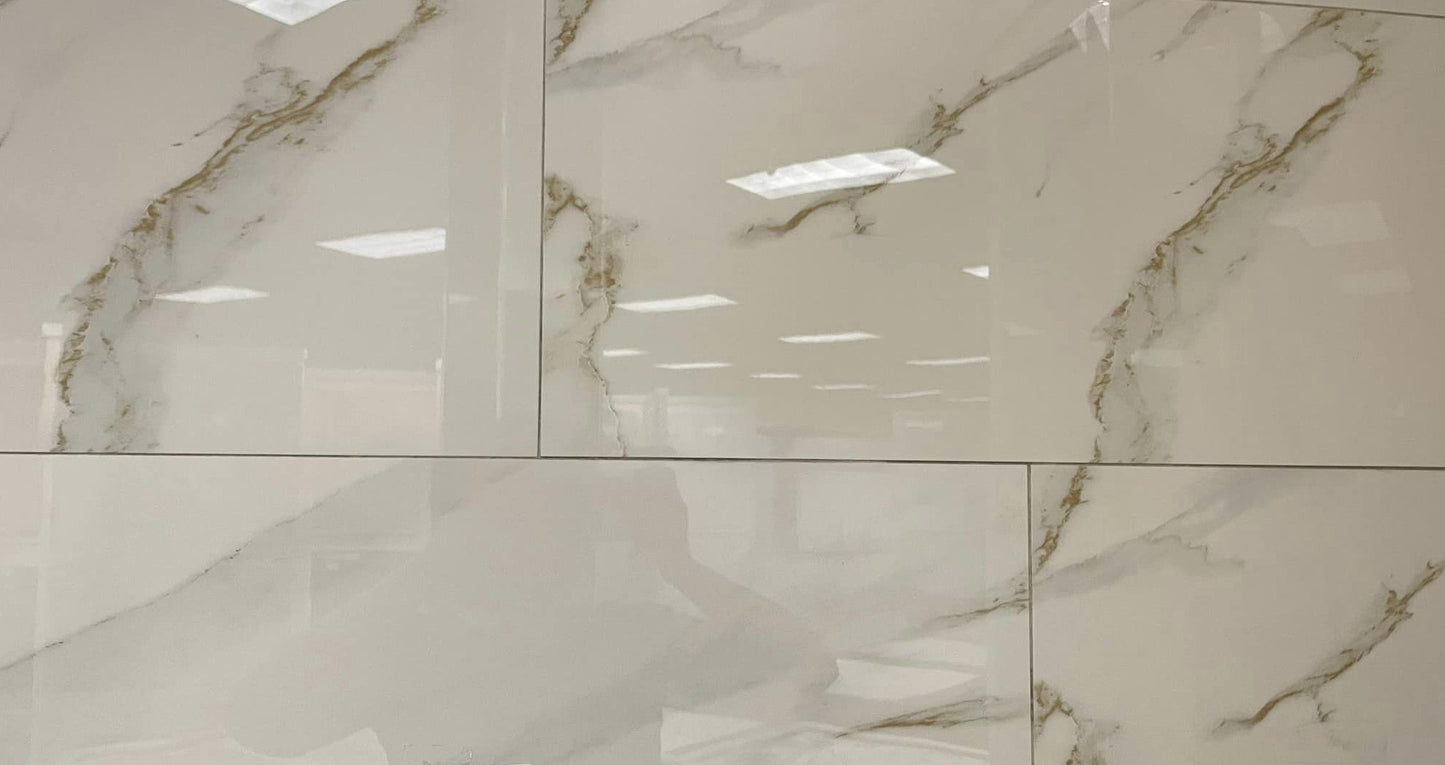Gold Rush polished porcelain tile with a white marble design, for floors and walls. In a 12x24" size.