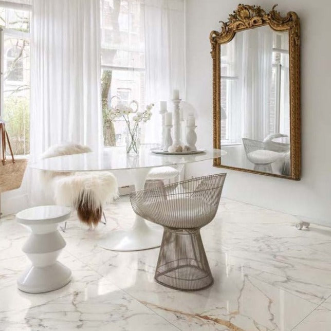 Golden White polished porcelain tile with a white marble design, for floors and walls. Made in Italy, installed in a room.