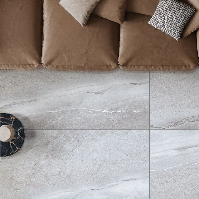 Iceland Grey polished porcelain tile with a grey marble/stone style for floors and walls. Installed in a room.