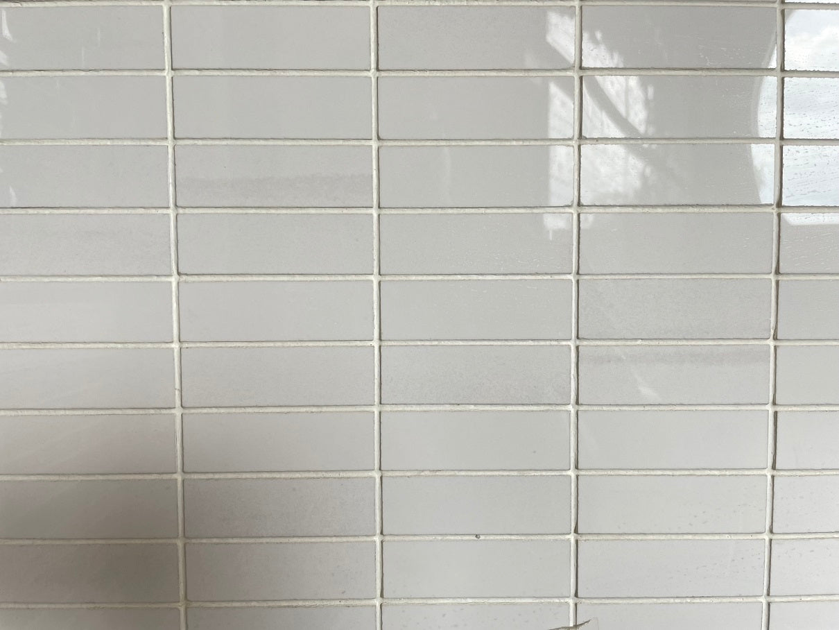 Imperial White polished porcelain tile with a pure white design, for floors and walls. In a 1x3" mosaic size.