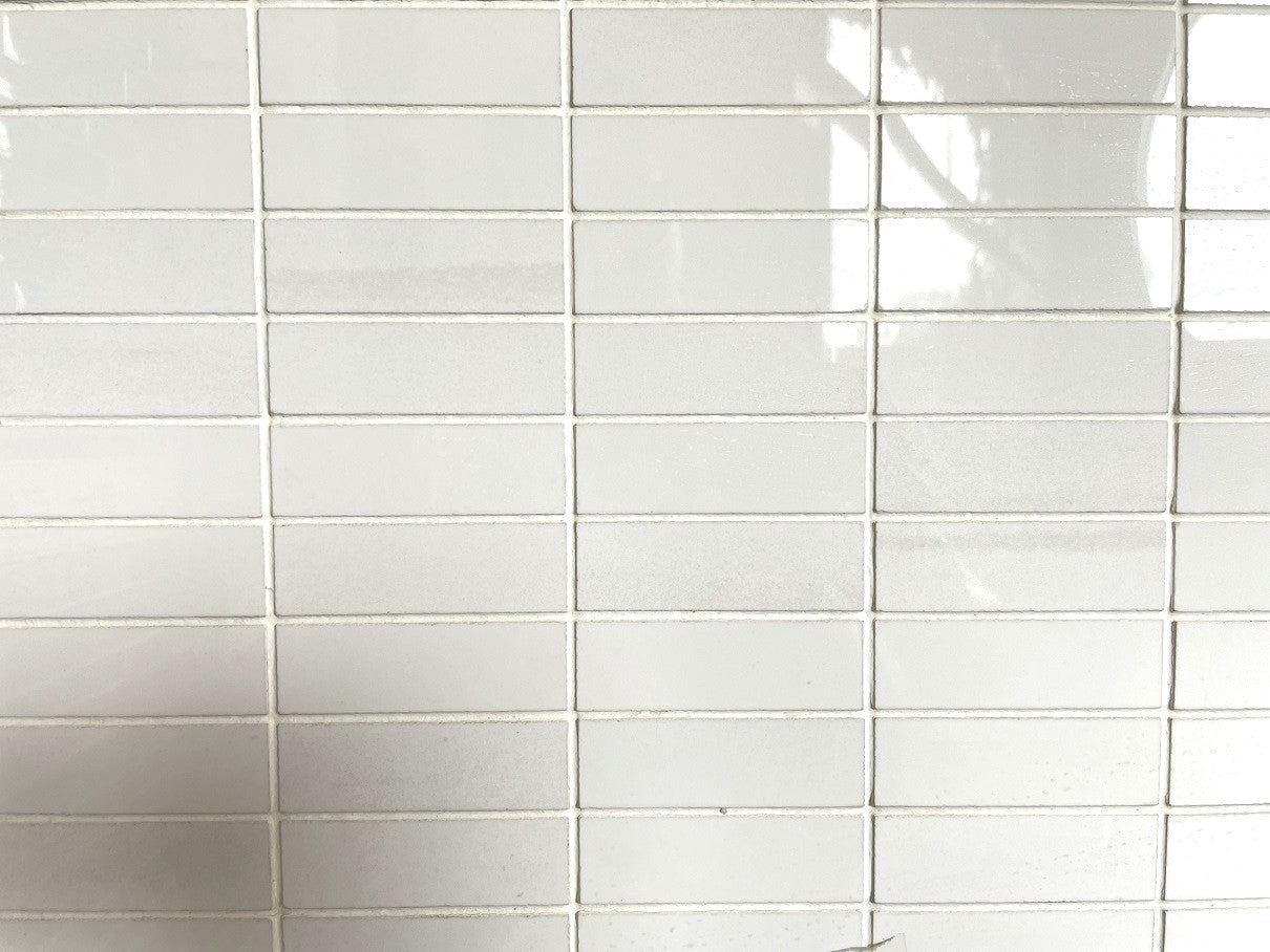 Imperial White polished porcelain tile with a pure white design, for floors and walls. In a 1x3" mosaic size.