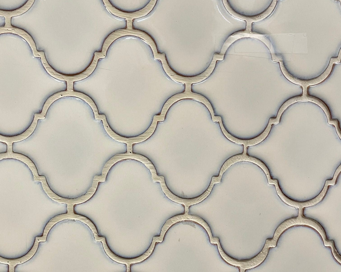 Lantern Cream glossy finish mosaic in a light cream colour, for backsplashes. In a symmetrical lantern shape.