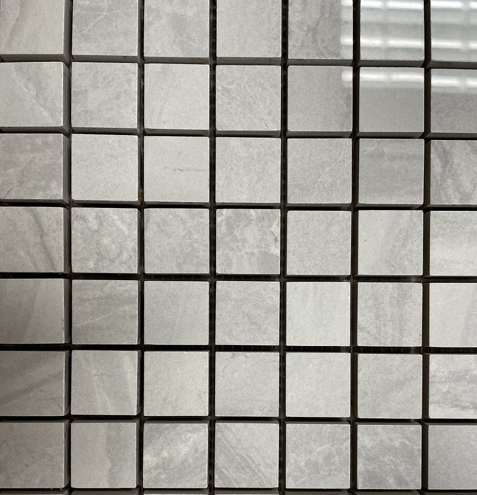 Lazio Mist polished porcelain tile with a grey stone design, for floors and walls. In a 1x1" mosaic size.