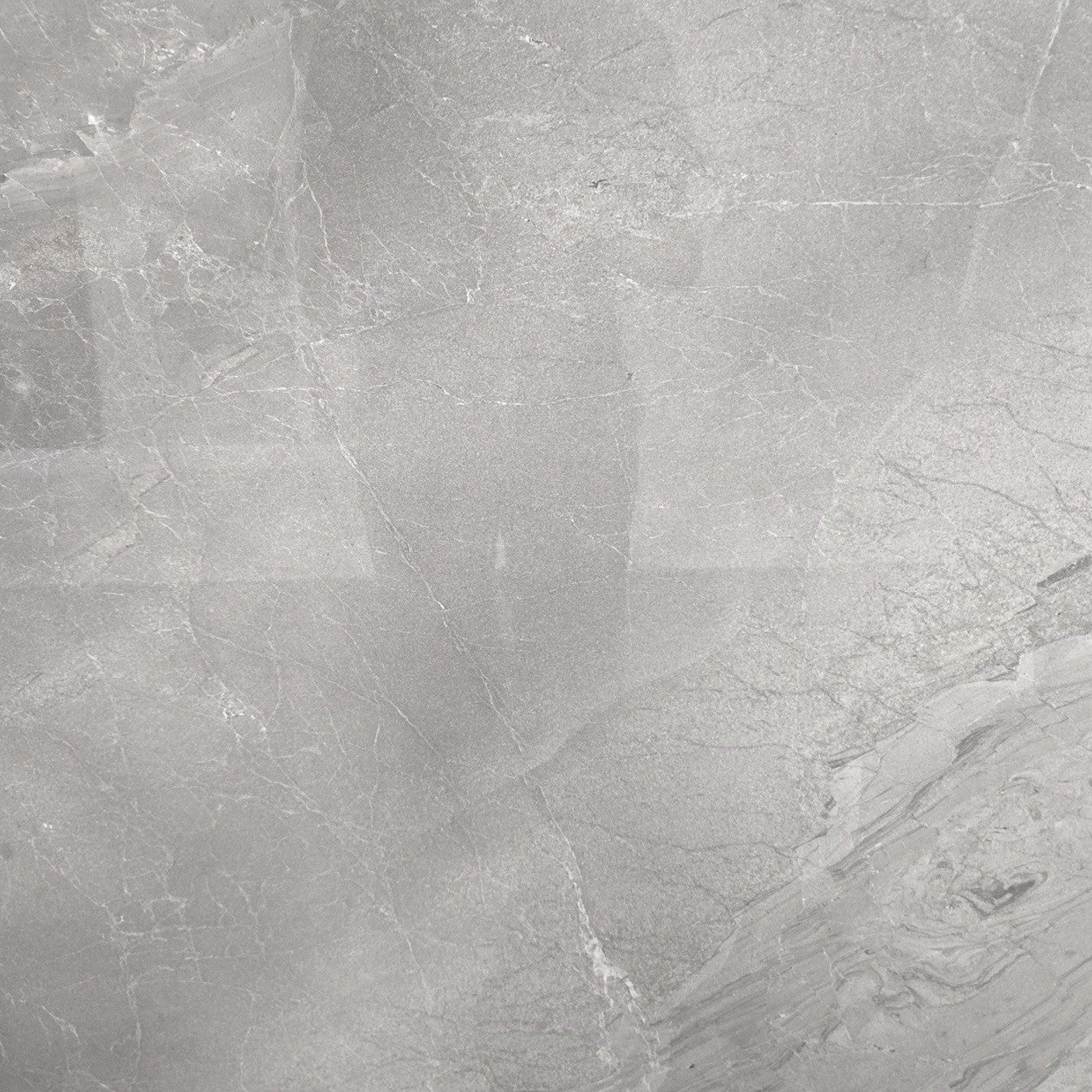 Lazio Silver polished porcelain tile with a stone design, for floors and walls. In a 32x32" size.