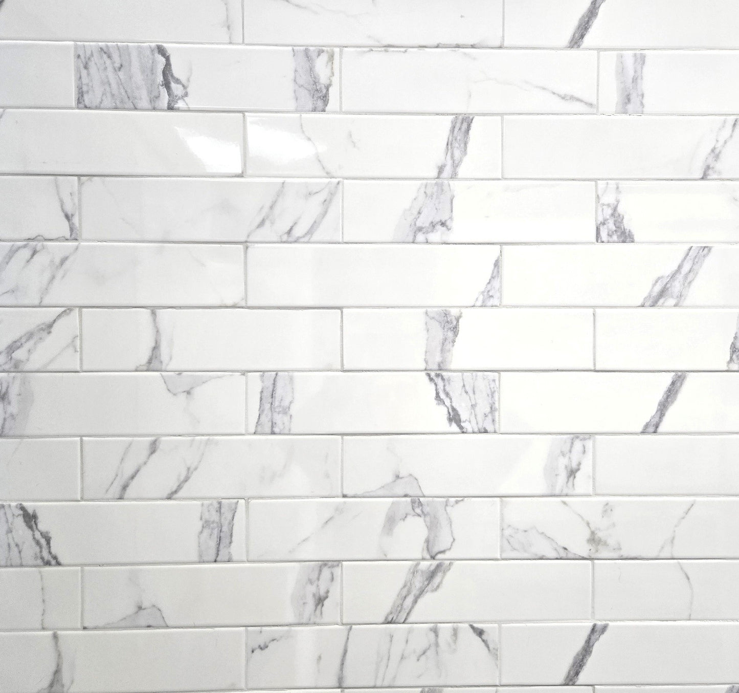 Calacata white marble style ceramic subway tile, for walls. Made in Spain, in a 3x12" size.