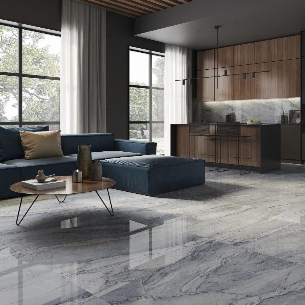 Macauba Blue polished porcelain tile with a marble design, for floors and walls. Made in Spain, installed in a room.