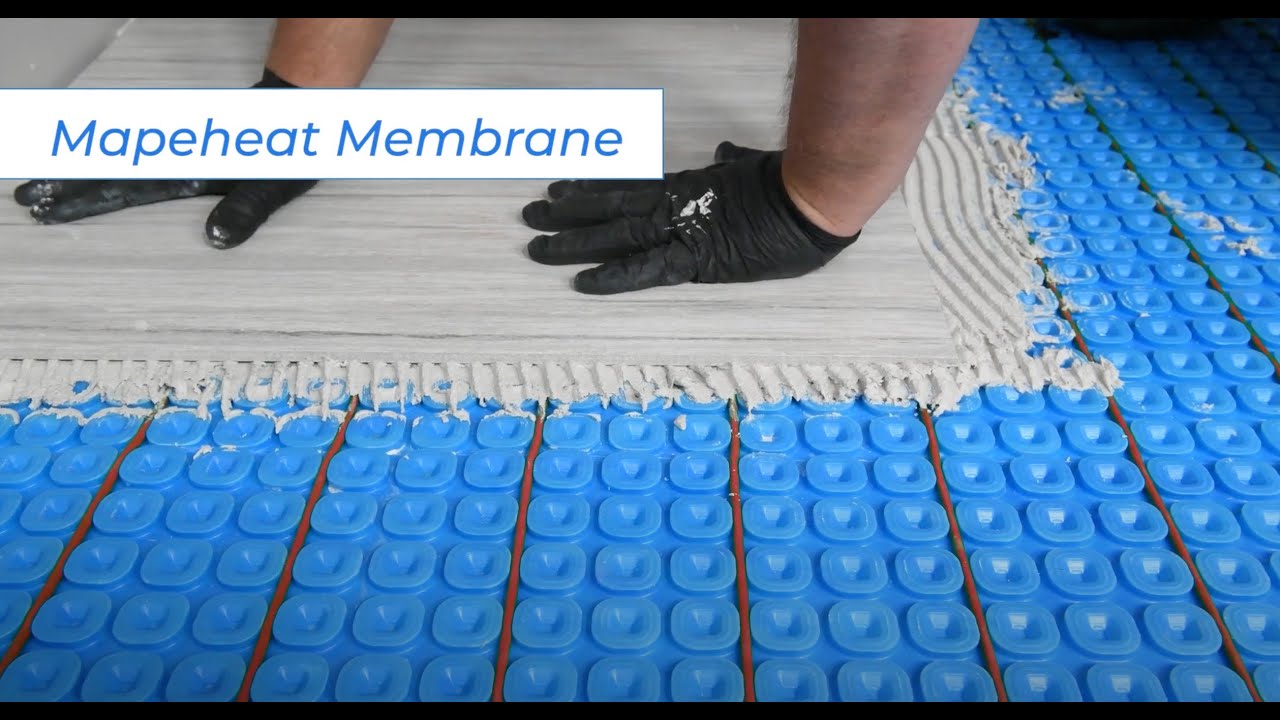 Mapei Mapeheat uncoupling membrane for use with heated floor cables, being installed with heat cables, cement and tile.