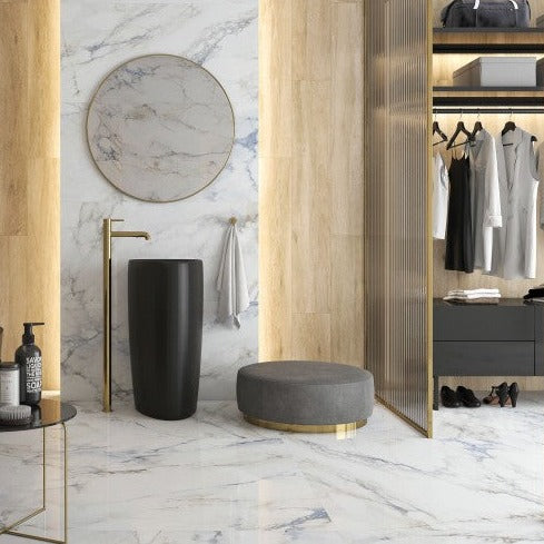 Mare polished porcelain tile with a white, blue, and gold marble design, for floors and walls. Installed in a room.