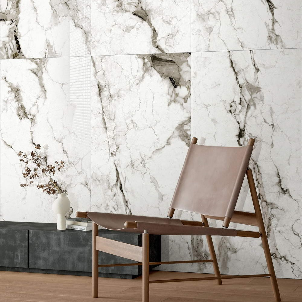 Marmo Divetente polished porcelain tile in a white and dark grey/black marble style. Installed on a wall.