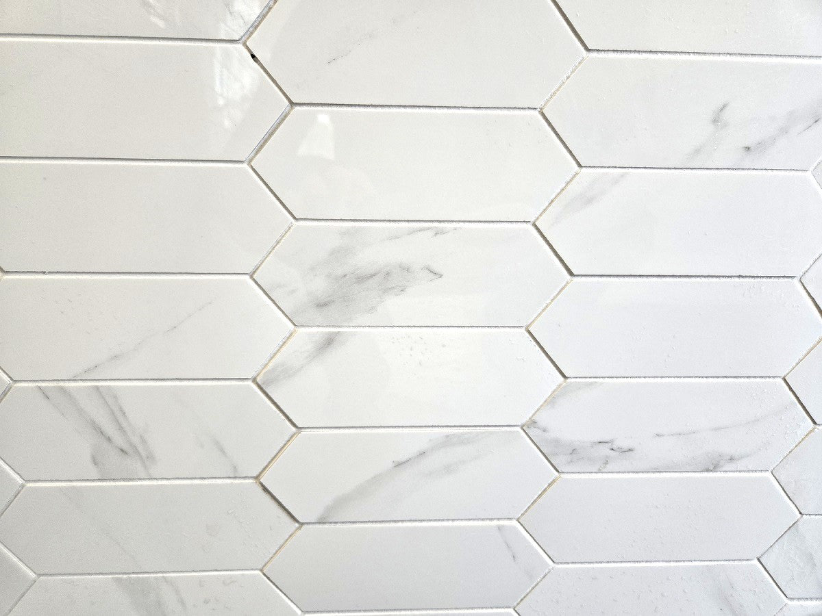 Marmo Julieta polished porcelain tile in a white marble style, for floors and walls. In an elongated hexagon mosaic.