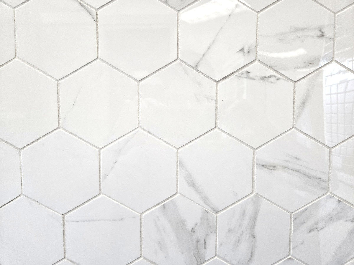 Marmo Julieta polished porcelain tile in a soft white marble style, for floors and walls. In a large hexagon mosaic.