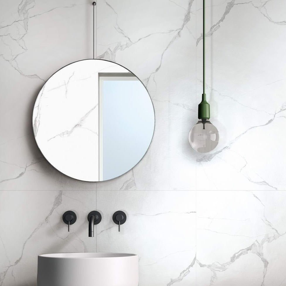 Marmo Tatiana matte porcelain tile in a white marble style, for floors and walls. Installed in a bathroom.