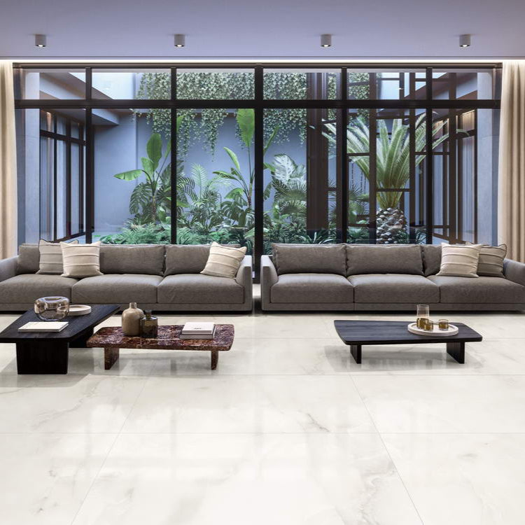 Marmo Umile polished porcelain tile in an off-white/beige onyx style, for floors and walls. Installed in a room.