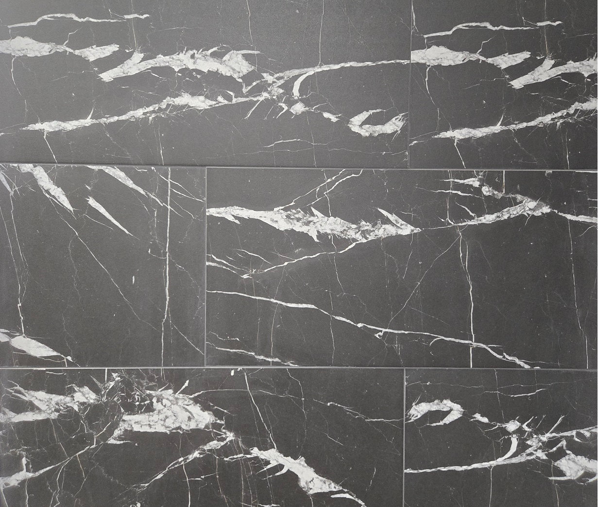 Marquina matte porcelain tile with a black and busy white vein pattern, for floors and walls. In a 12x24" size.