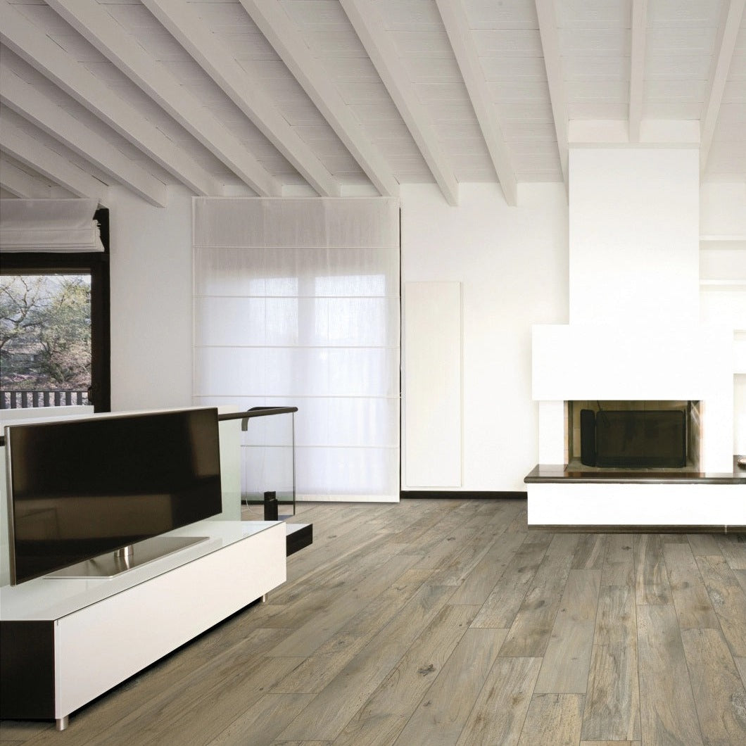 Memory Miele matte porcelain tile with a beige wood design, for floors and walls. Made in Italy, installed in a room.