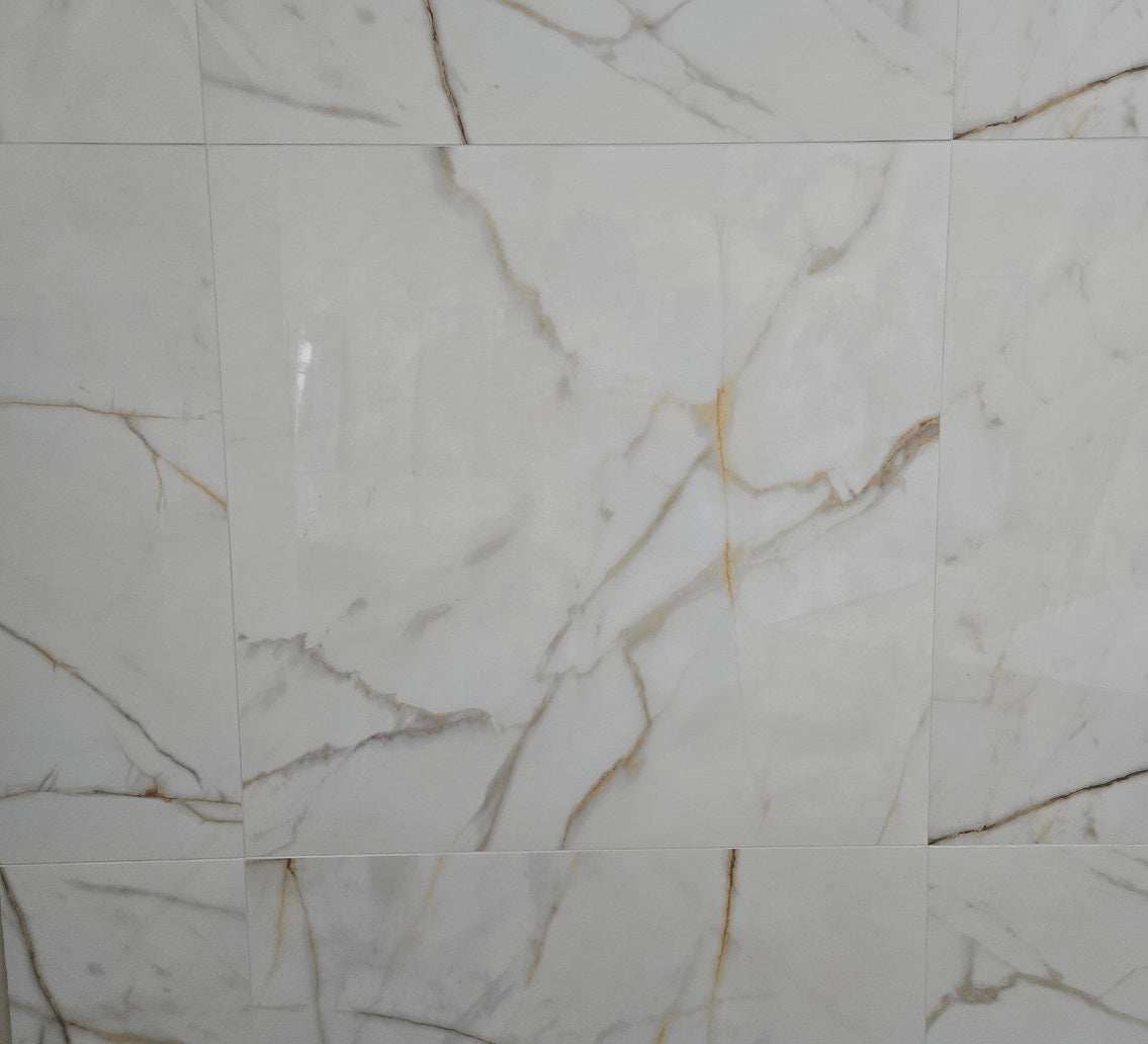 Miami Gold polished porcelain tile with a white, gold, and silver marble style, for floors and walls. In a 24x24" size.