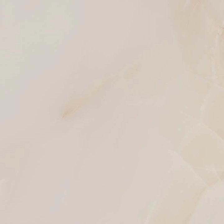 Mirage Warm glossy porcelain tile with a beige onyx design, for floors and walls. Made in Spain, in a 24x24" size.