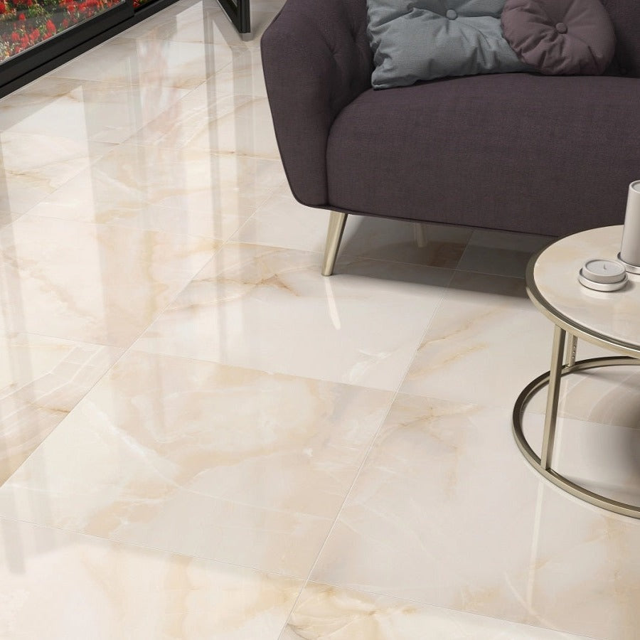 Mirage Warm glossy porcelain tile with a beige onyx design, for floors and walls. Made in Spain, installed in a room.