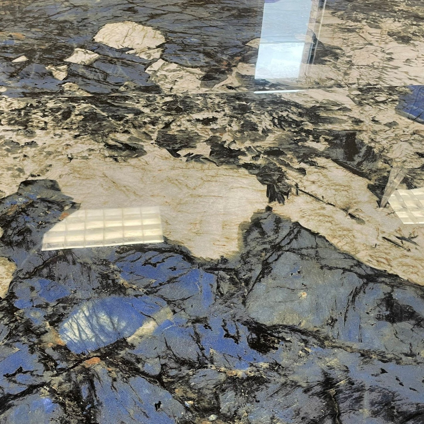 Morning Glory polished porcelain tile with white, blue, and black colours. In a 30x60" size.