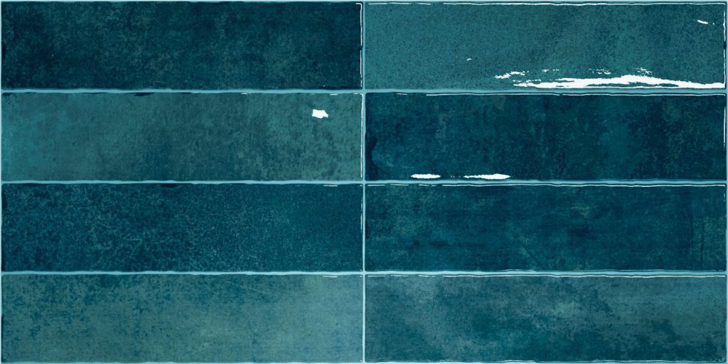 Nairobi Blue artisan style glossy ceramic subway tile with non-flat edge and surface. Made in Spain, in a 3x12" size.
