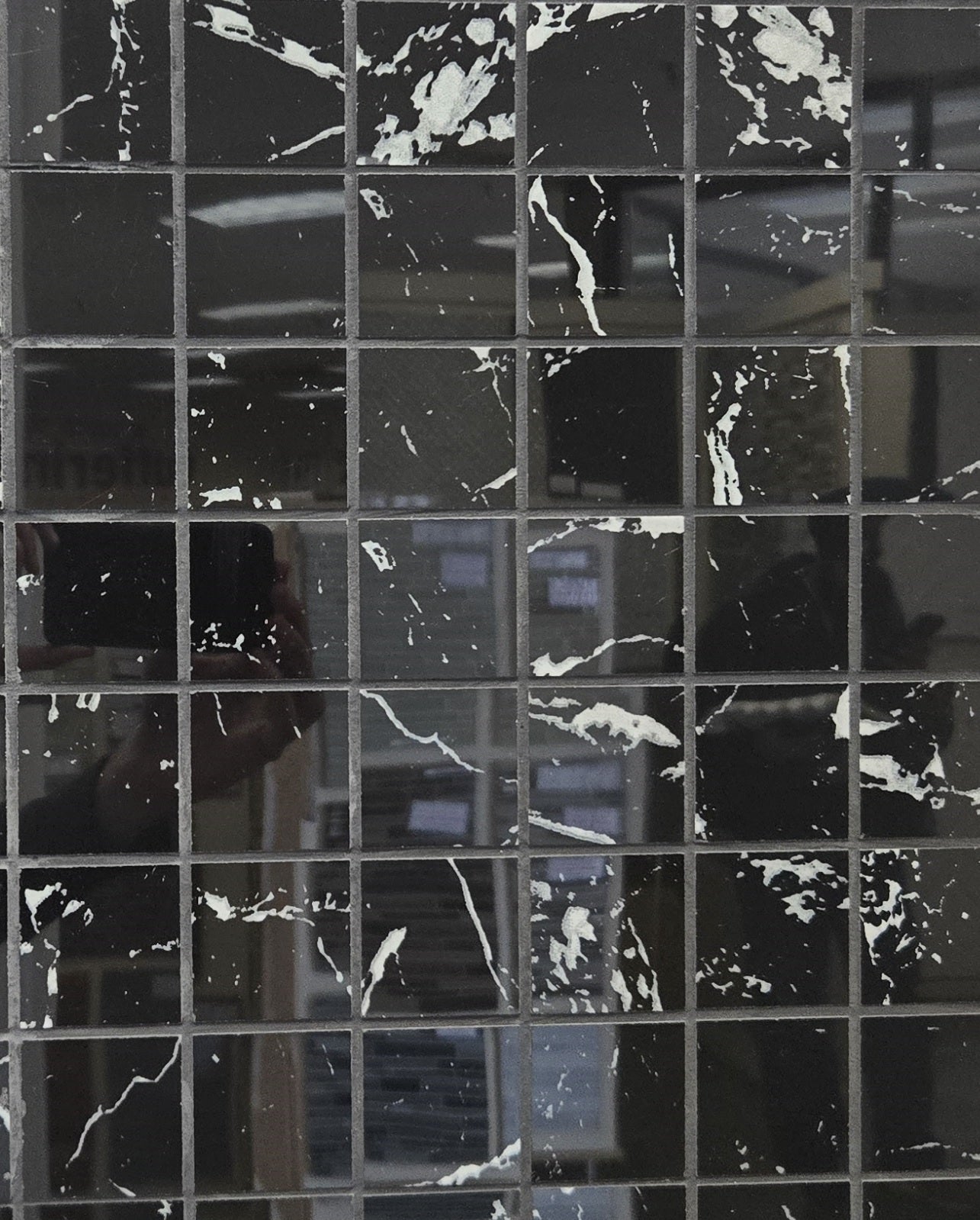 Nero Marquina polished porcelain tile with black marble design, for floors and walls. In an square mosaic shape.