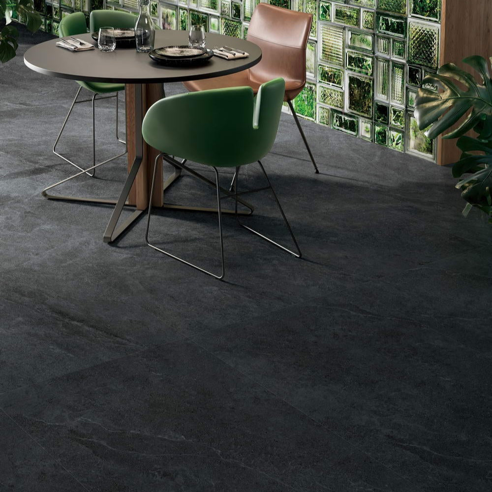Nordic Charcoal matte porcelain tile with a dark grey/black stone look, for floors and walls. Installed in a room.