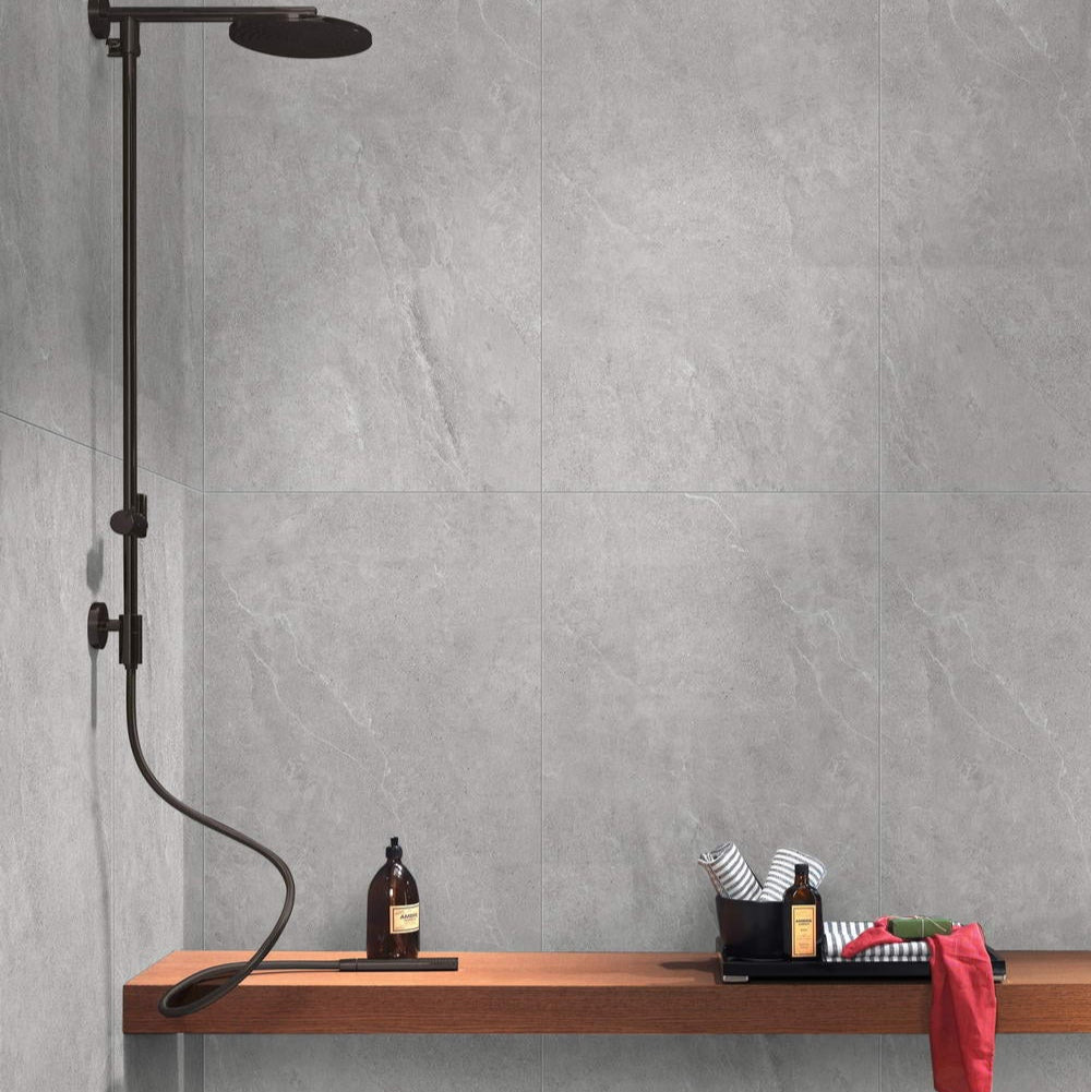 Nordic Grigio matte porcelain tile with a light grey stone look, for floors and walls. Installed in a room.